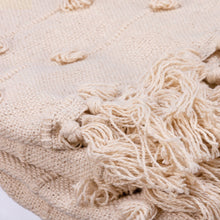 Load image into Gallery viewer, Close-up of a beige knitted blanket with tassels on a white background