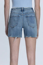 Load image into Gallery viewer, Person wearing light blue denim shorts on a white background