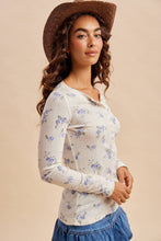 Load image into Gallery viewer, Woman wearing a floral long-sleeve shirt and a brown hat against a beige background