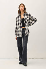 Load image into Gallery viewer, Person wearing a black and white checkered shirt with black pants on a white background