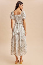 Load image into Gallery viewer, Woman wearing a floral dress against a beige background