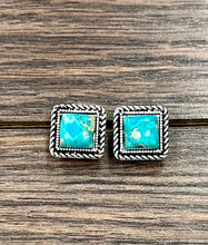 Load image into Gallery viewer, Square turquoise stone earrings with silver wire border on a wooden surface