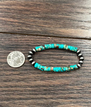 Load image into Gallery viewer, Turquoise and black beaded bracelet on a wooden surface with a quarter for scale.