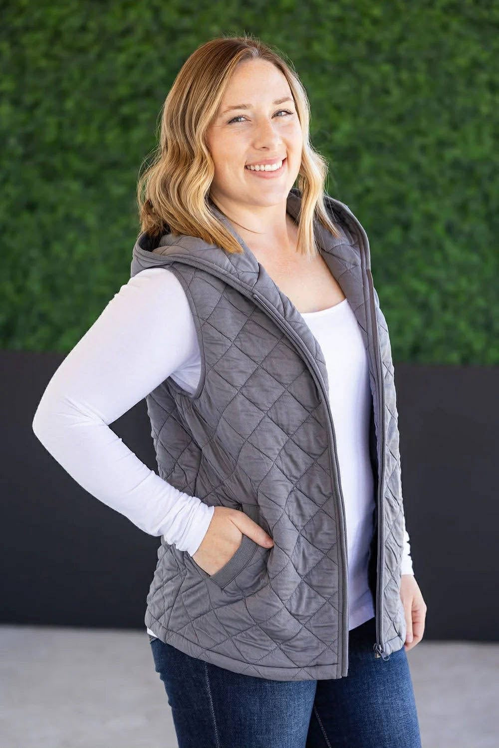 woman wearing grey vest