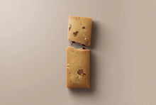 Load image into Gallery viewer, Two chocolate chip cookie bars on a beige background