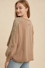 Load image into Gallery viewer, Woman wearing a beige long-sleeve top with lace sleeves against a beige background