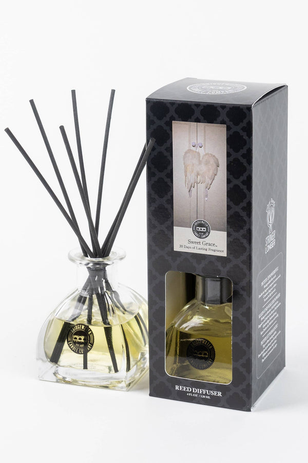 Reed diffuser with packaging on a white background