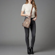 Load image into Gallery viewer, Woman holding a patterned bag against a gray background