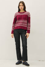 Load image into Gallery viewer, Model wearing a patterned sweater and dark jeans on a white background