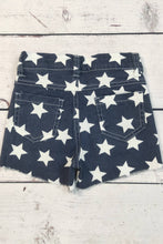 Load image into Gallery viewer, Navy denim shorts with white star pattern on a wooden surface