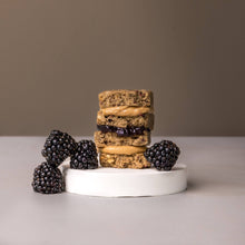 Load image into Gallery viewer, Stack of cookies with blackberries on a white base against a neutral background