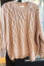 Load image into Gallery viewer, Beige cable knit sweater on a mannequin against a blurred indoor background