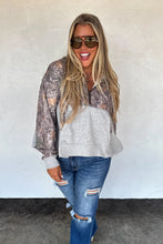 Load image into Gallery viewer, Woman wearing a patterned jacket and ripped jeans against a plain background