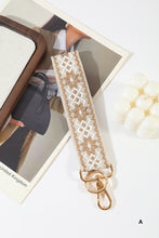 Load image into Gallery viewer, Lace strap with gold hardware on a white surface