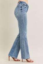 Load image into Gallery viewer, Light blue jeans worn by a person on a beige background