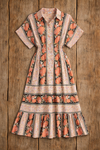 Load image into Gallery viewer, Short-sleeve dress with floral pattern on a wooden surface