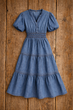 Load image into Gallery viewer, Blue denim dress on a wooden surface
