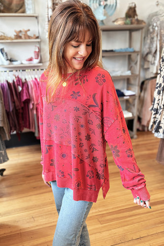 girl wearing red sweatshirt with floral print