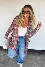 Load image into Gallery viewer, Woman wearing a plaid shirt, white top, and jeans, posing against a white wall.
