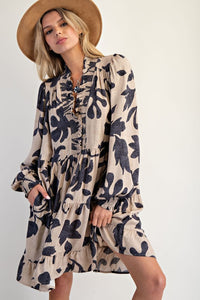 Woman wearing a floral dress and hat on a white background