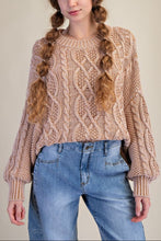 Load image into Gallery viewer, Woman wearing a beige cable knit sweater and blue jeans against a plain background