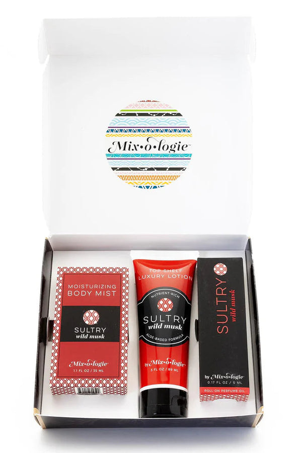 A gift set box labeled 'Mixologie' containing rollerball perfume, moisturizing body mist, and luxury lotion.