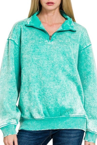 Woman wearing a turquoise fleece pullover on a white background