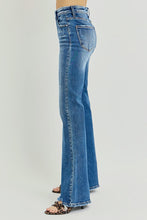 Load image into Gallery viewer, Blue jeans worn by a person on a light gray background