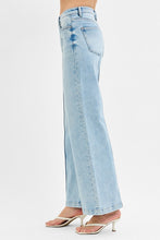Load image into Gallery viewer, Light blue jeans worn by a person on a white background
