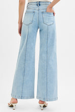 Load image into Gallery viewer, Light blue jeans worn by a person on a white background