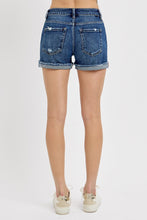 Load image into Gallery viewer, Blue denim shorts worn by a person on a white background