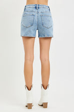 Load image into Gallery viewer, Light blue denim shorts worn by a person on a white background