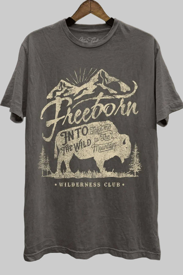 Gray t-shirt with mountain and bear graphic on a wooden background