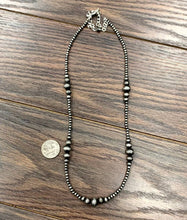 Load image into Gallery viewer, Necklace with beads on a wooden surface, next to a coin for scale