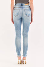 Load image into Gallery viewer, Light blue jeans worn by a person on a white background
