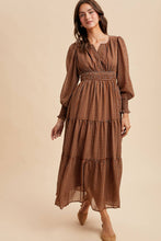 Load image into Gallery viewer, Woman wearing a brown patterned dress on a beige background