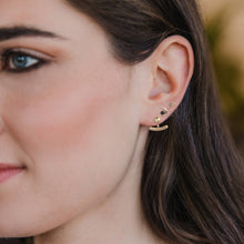 Load image into Gallery viewer, Close-up of a woman wearing gold hoop earrings with small stones.