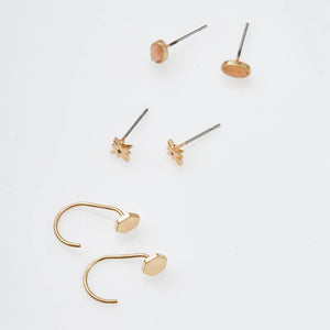 Set of gold earrings on a white background