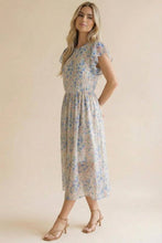 Load image into Gallery viewer, Woman wearing a floral dress against a plain background