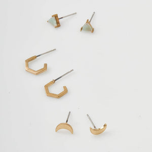 Set of gold earrings on a white background