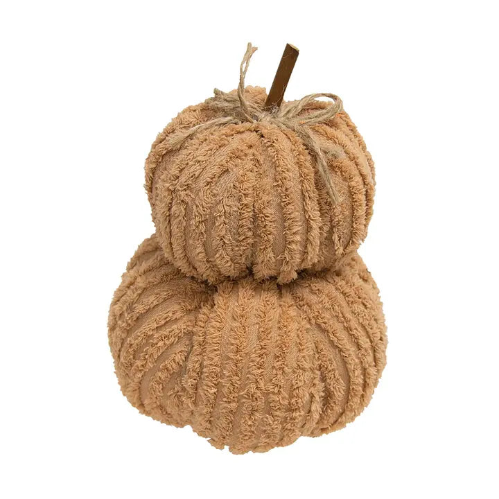 A decorative stacked pumpkin decoration made from chunky ribbed chenille yarn in a warm tan color, with a small brown stem and twine bow at the top, shown on a plain white background.