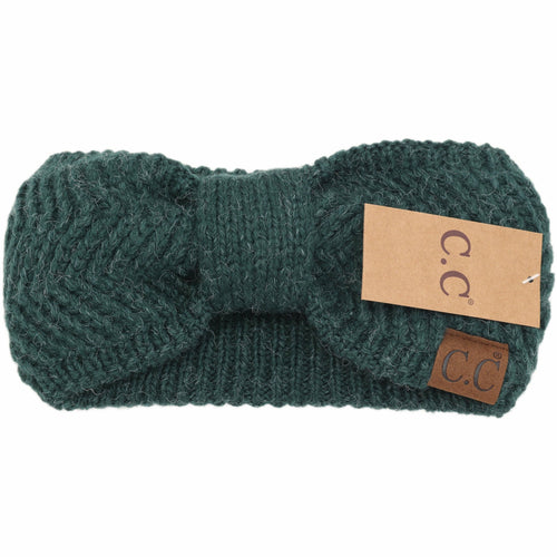 Green knitted headband with a brand tag on a white background