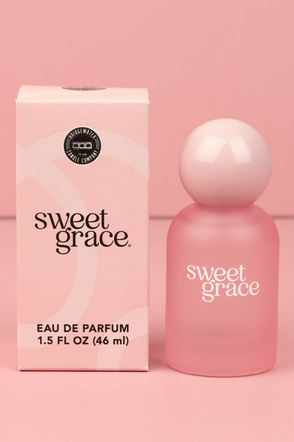 Pink 'sweet grace' eau de parfum bottle and packaging on a pink background
