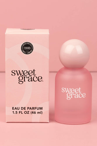 Pink 'sweet grace' eau de parfum bottle and packaging on a pink background