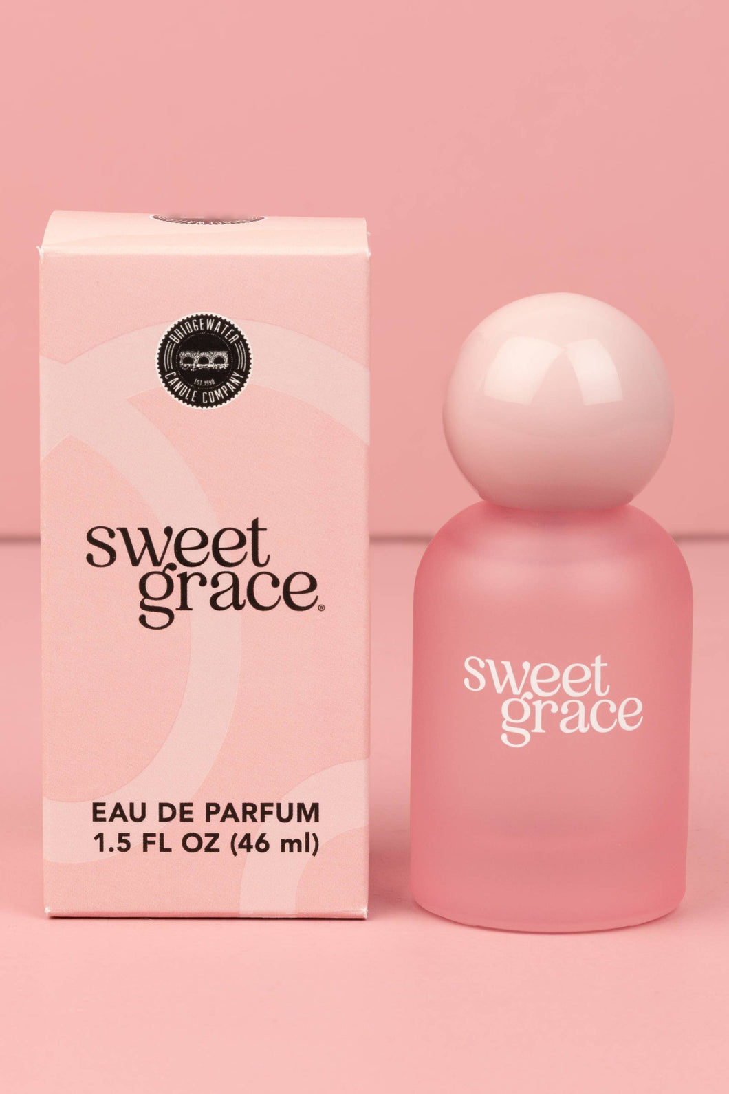 Pink 'sweet grace' eau de parfum bottle and packaging on a pink background