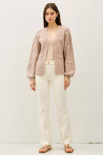 Load image into Gallery viewer, Woman wearing a light pink cardigan with floral embellishments on a white background