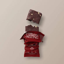 Load image into Gallery viewer, Red velvet protein bar with packaging on a beige background