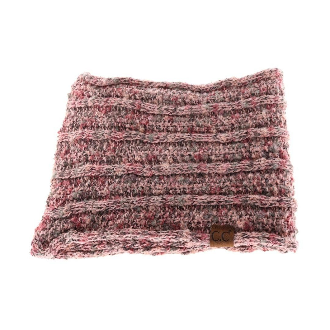 Textured pink and brown scarf with a brand label on a white background