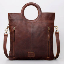 Load image into Gallery viewer, Brown leather handbag with gold accents on a light gray background