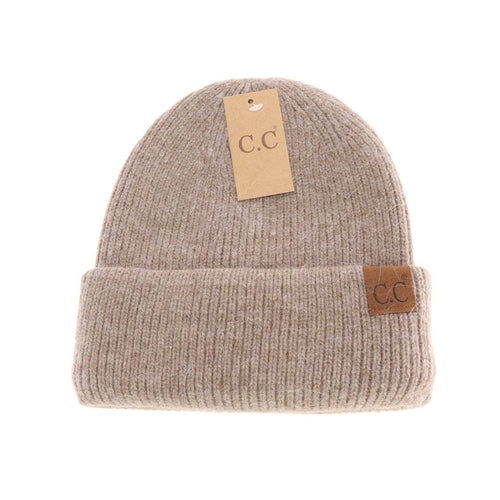 Beige knit beanie with C.C tags on a white background